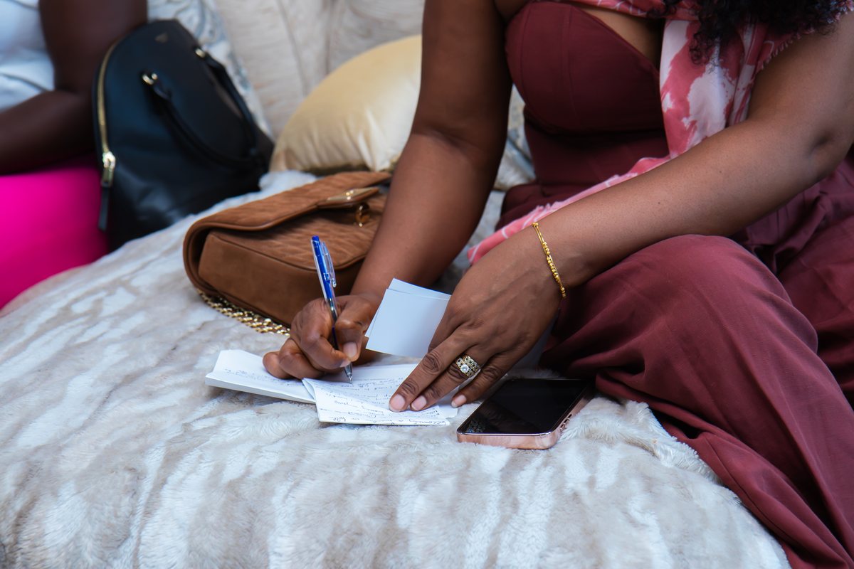 A woman writing in a notebook at The MEND Experience
